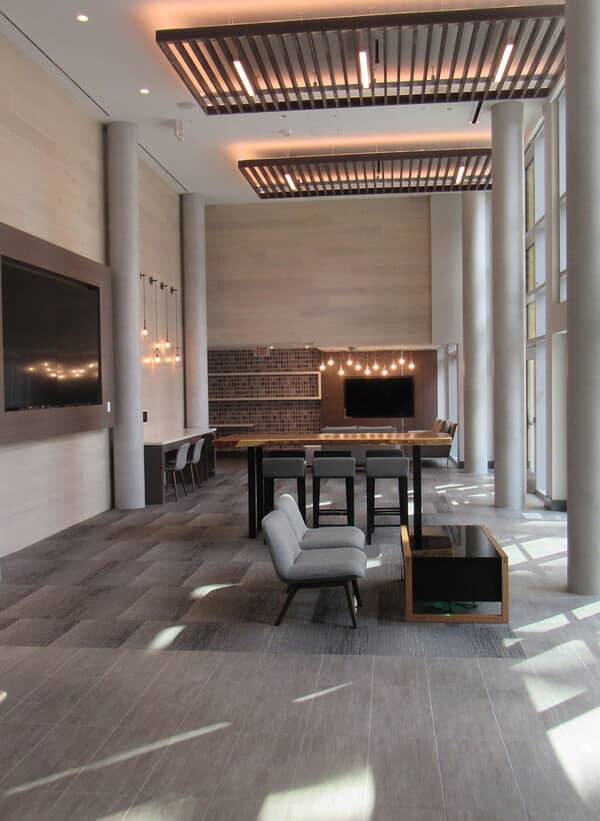 Residents' dining room with a textured plaster feature wall behind a long table