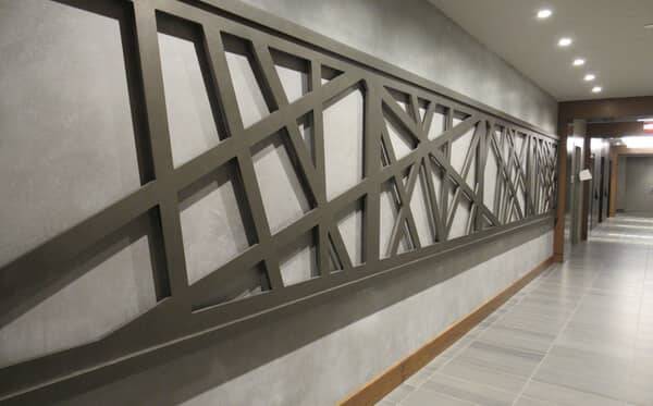 Corridor with a lattice feature wall finished in custom plaster