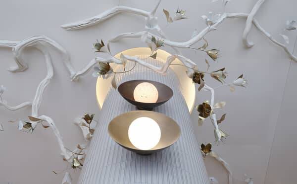 Sculptural plaster ceiling with branching relief around pendant lights