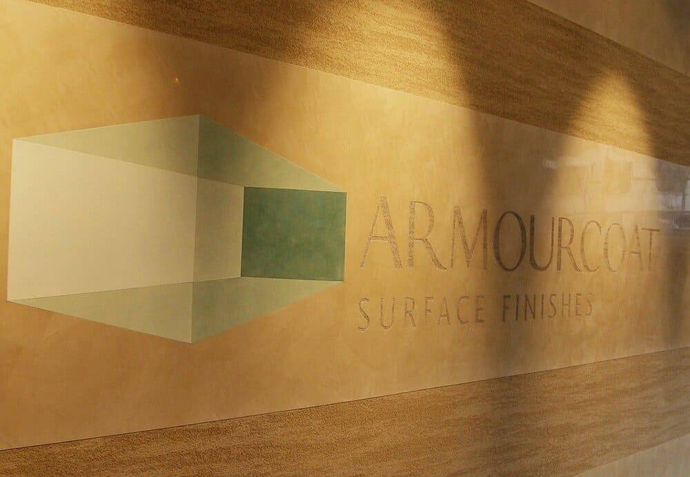 Polished Armourcoat plaster wall with the brand's surface-finishes signage