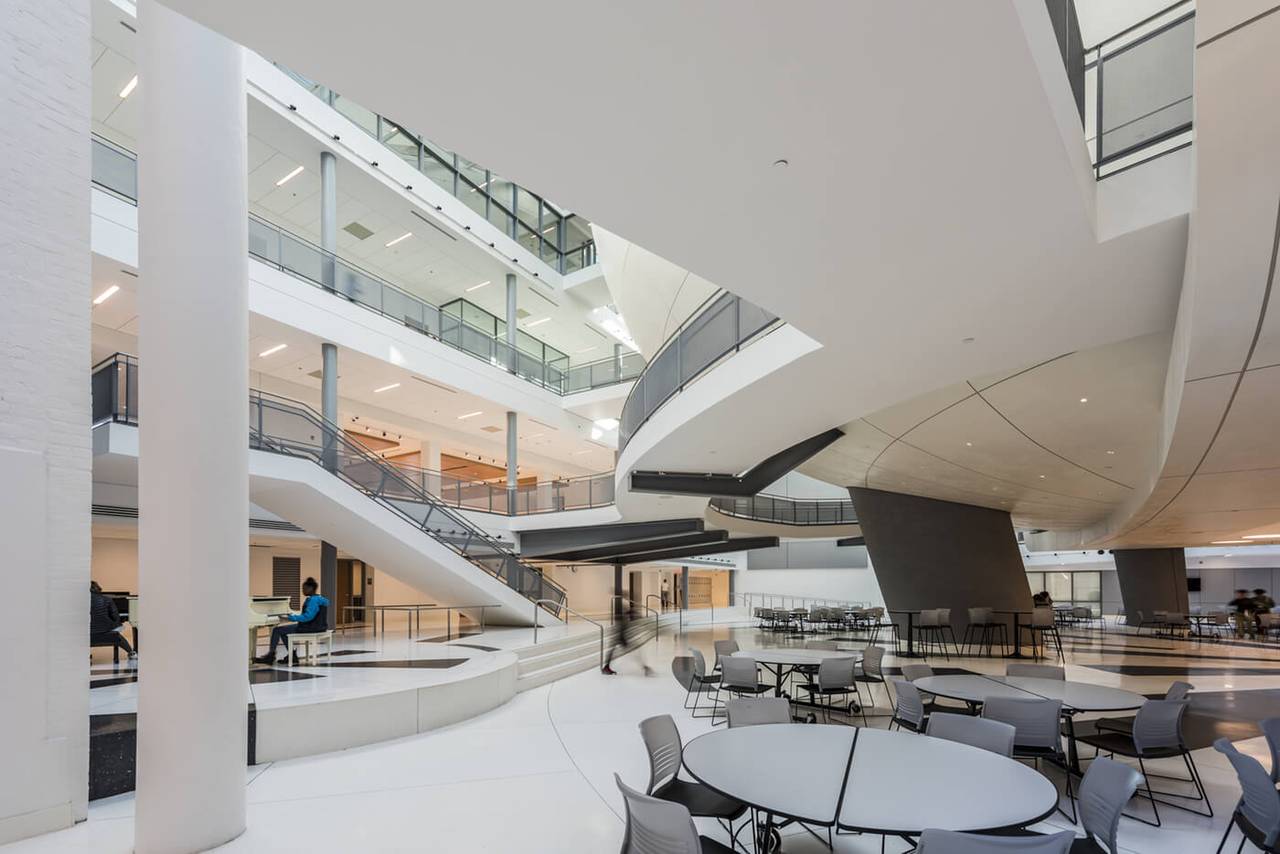 Office atrium with sculpted plaster balustrades and a curved mezzanine soffit