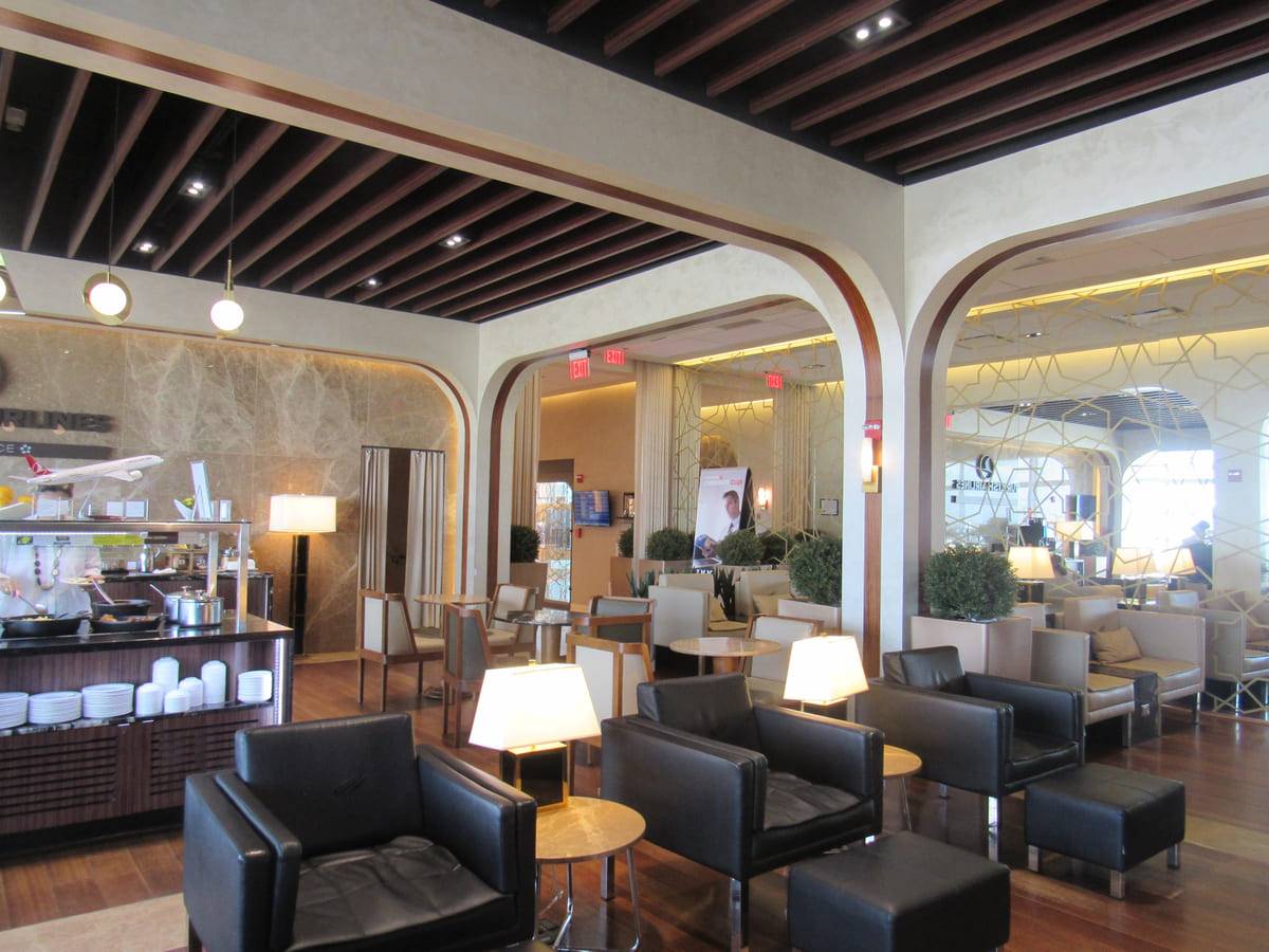 Hotel lounge with custom-matched plaster walls under a timber slat ceiling