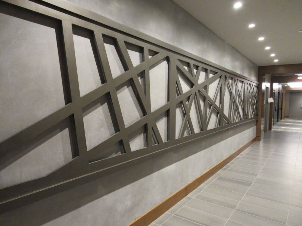 Corridor with a lattice feature wall finished in custom plaster
