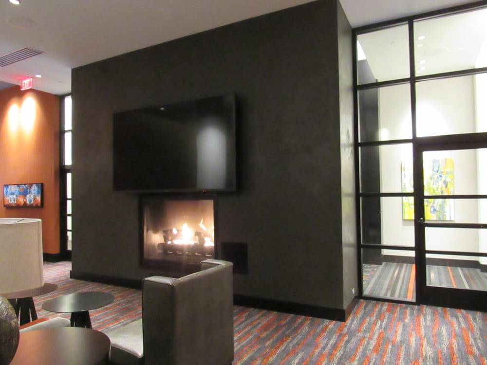 Lounge fireplace with a plaster chimney breast under a mounted screen