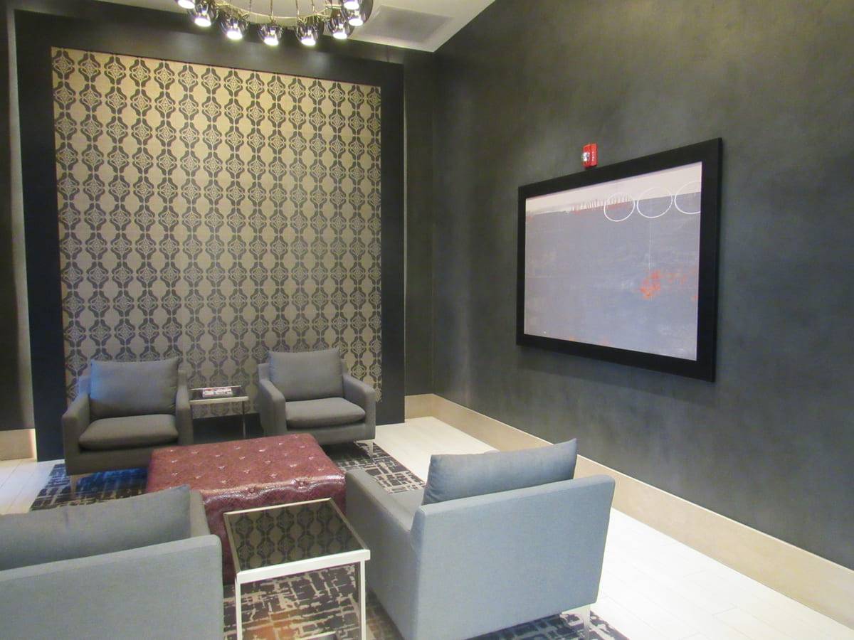 Media room at Pike 3400 Apartments with a burnished Armurella plaster wall