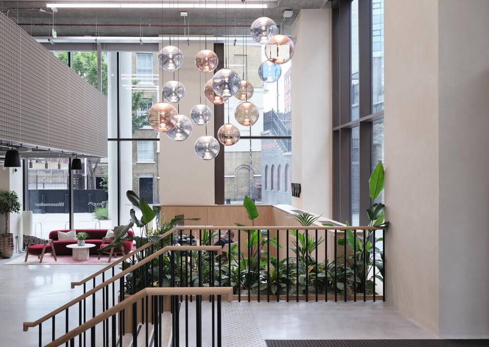 Residential mezzanine lounge with clay lime plaster walls and a glazed façade