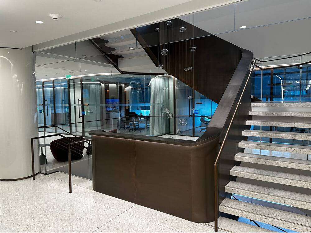 Office atrium stair with a seamless acoustic plaster soffit