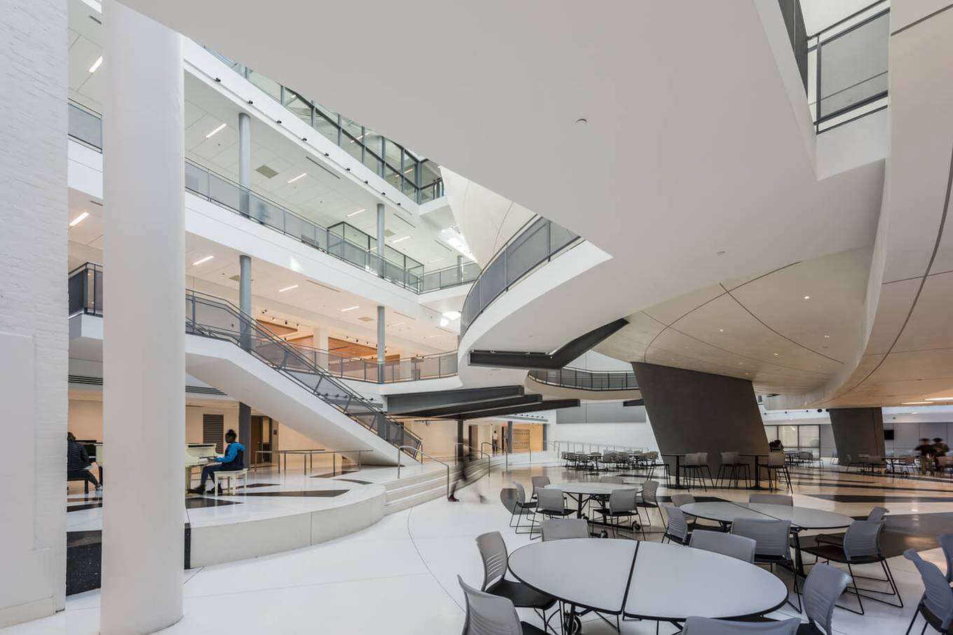 Office atrium with sculpted plaster balustrades and a curved mezzanine soffit