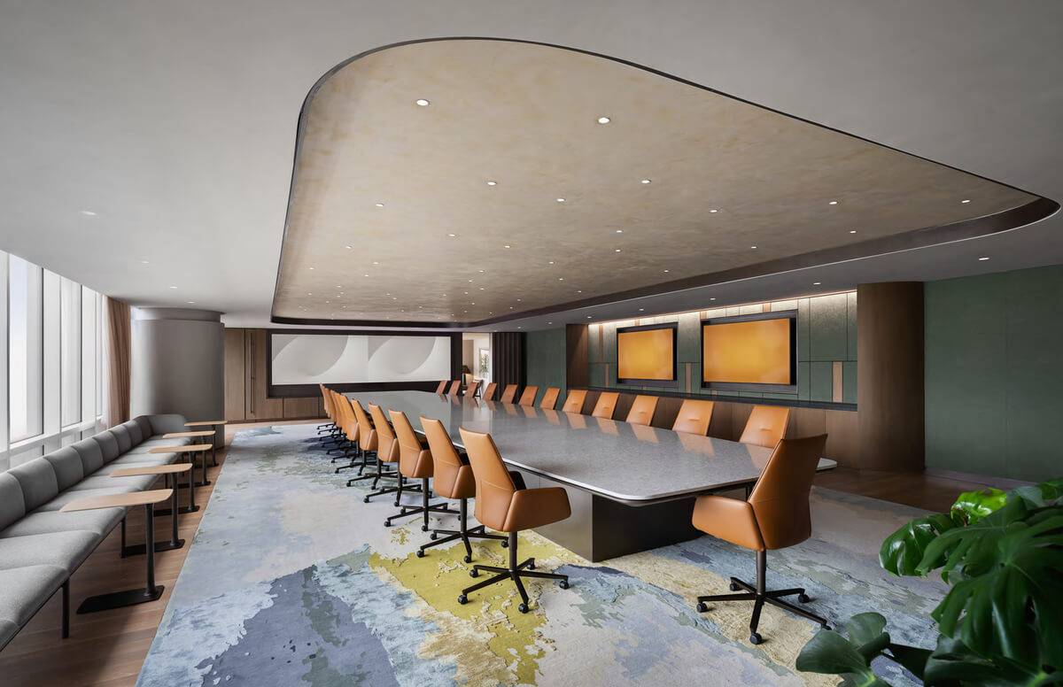 Boardroom with a curved acoustic plaster ceiling above a long conference table