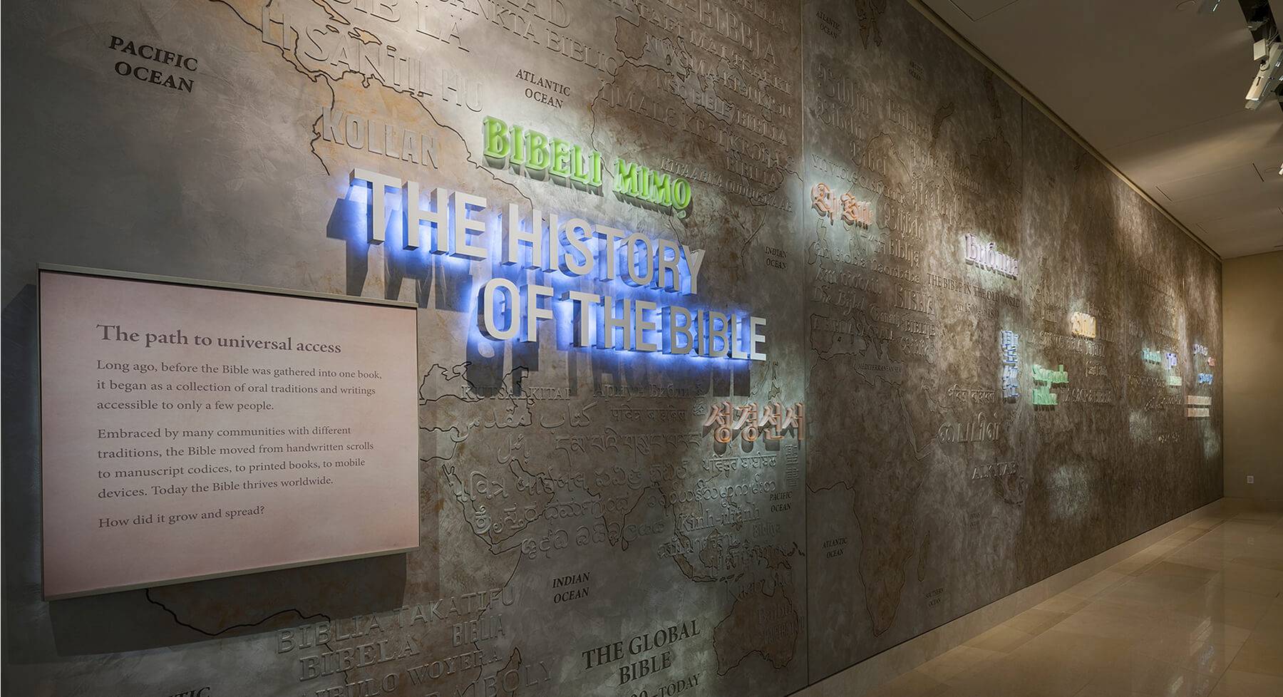 Museum gallery wall in burnished Venetian plaster with an illuminated map and signage