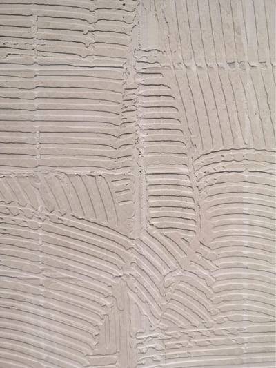 Fan-raked plaster in warm grey