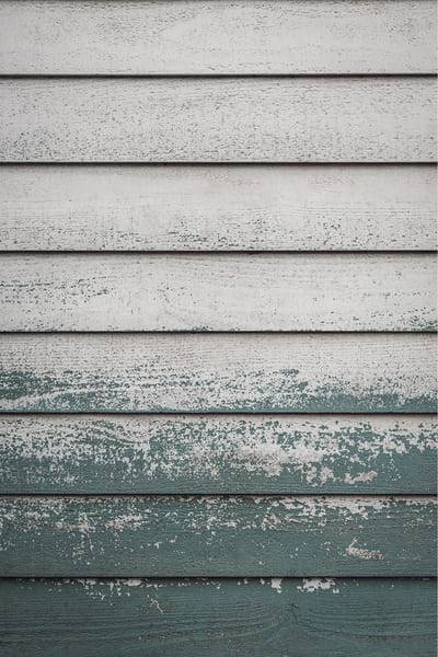 Weathered horizontal plaster bands in grey-green