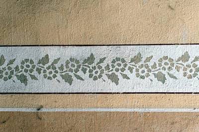 Floral stencil frieze on a sand ground