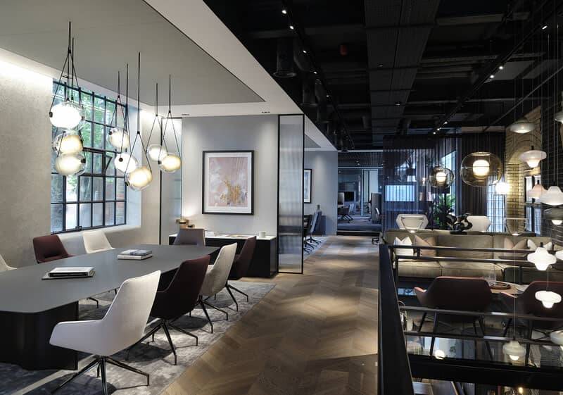 Open-plan office with seamless plaster surfaces and pendant lighting
